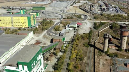 An Aerial View of an Expansive Industrial Area Featuring Railroads and Green Buildings Nearby Stock
