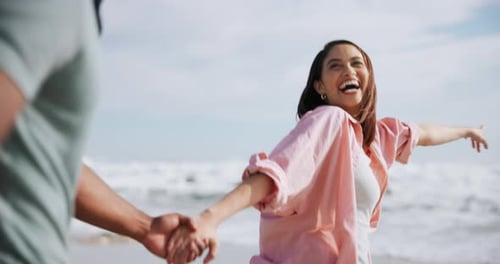 Happy, couple and running with holding hands on beach for freedom, excited