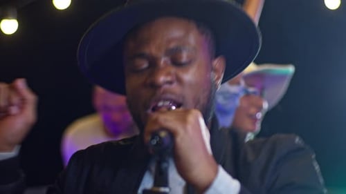 Close Up of Beautiful Young African American Man Singing Song on a Rooftop Party Friends Enjoying