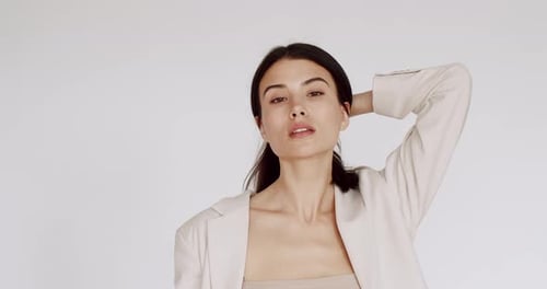 Woman Posing with Long Dark Hair and Beige Jacket