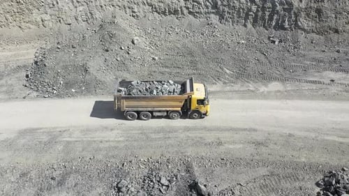 Dump Truck Hauling Rocks in Quarry Aerial Shot