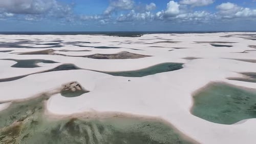 Couple Hiking on White Sand Dunes with Lagoons