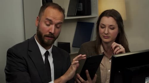 Colleagues Collaborating in an Office with Tablet