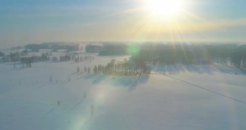 Aerial View of Cold Winter Landscape Arctic Field Trees Covered with Frost Snow Ice River and Sun