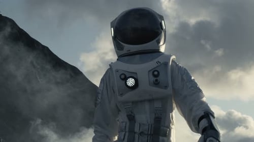 Medium Shot of the Astronaut Wearing Space Suit Walking and Exploring Gray Frozen Rocky Alien Plane
