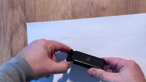 A Man Is Unboxing And Reviewing A Smartphone Holder. High Angle Shot.