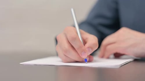 Close up of Businessman Hand Writing a Letter