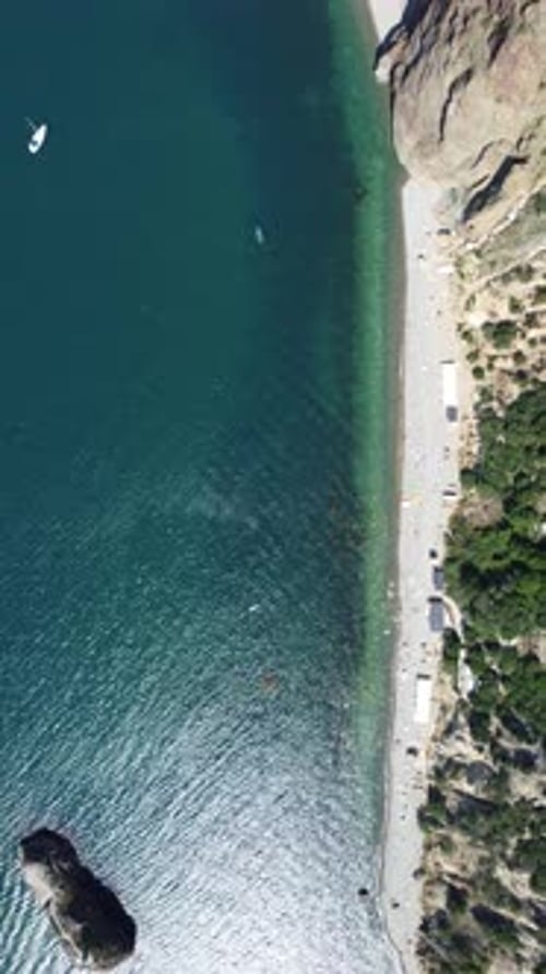 Aerial View From Above on Calm Azure Sea and Volcanic Rocky Shores Small Waves on Water Surface in