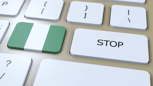 Pressing Stop Key with Nigerian Flag on Computer Keyboard