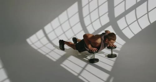 Man Doing Push Ups Using Dumbbells