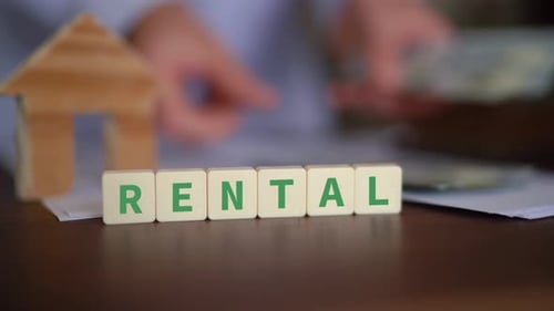 Blocks Spelling 'Rental' With Money and House