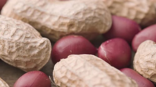 Closeup view of fresh peanuts on wooden table. Macro shot