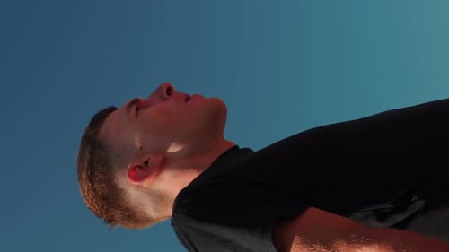 Sportive strong man with muscular body exercising on sports bar. Vertical video