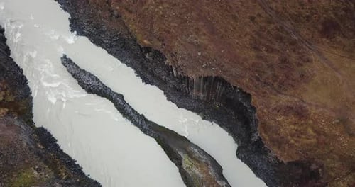 Birds Eye Aerial View on Natural Wonder of Iceland, Volcanic Basalt Steep Canyon and Glacial River.