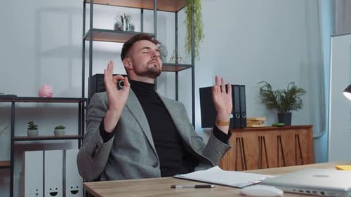 Businessman Working on Laptop Meditating Doing Yoga Breathing Exercise in Lotus Position at Office