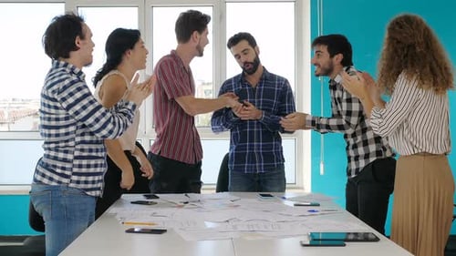 Team Celebrates Success in Office Workplace