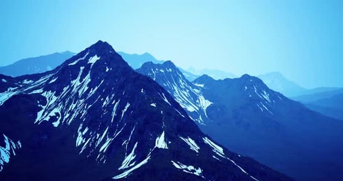 Snowcapped Mountain Range Under a Twilight Sky in a Remote Location