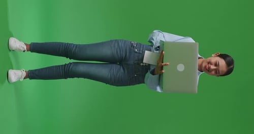 Full Body Of Asian Business Woman Using Laptop Computer On Green Screen Background In The Studio