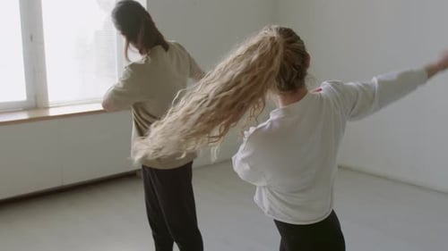 Woman and Man Doing Warmup Exercise in Dance Studio