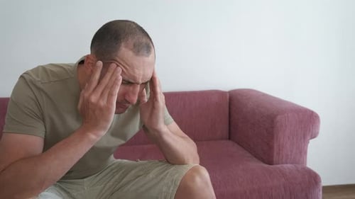 Man Suffering with Headache Indoors