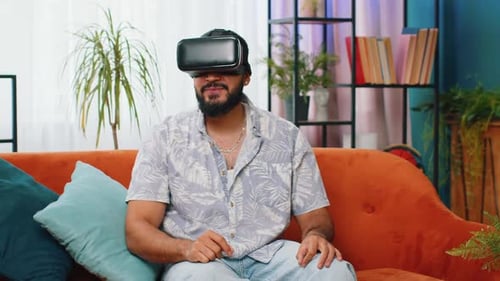 Man Experiencing Virtual Reality on Couch Indoors