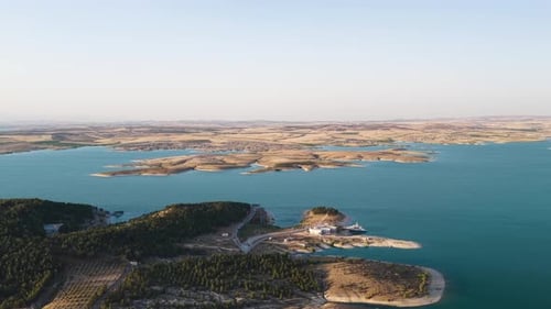 Aerial Video of Riverbanks and Crop Fields in Warm Light View of Sunset Over Rural Farmland