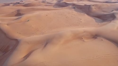 Golden Hour Drone View of an Isolated Desert with Towering Dunes and Peaks
