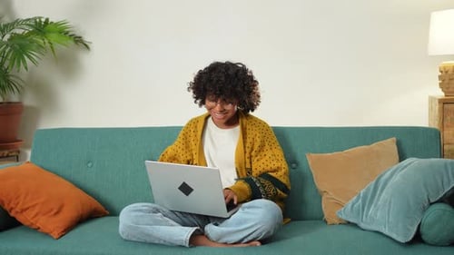African American Girl Using Laptop at Home Office Looking at Screen Typing Chatting Reading Writing