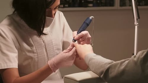 Woman Giving Manicure in Beauty Salon