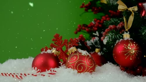 Christmas Ornaments with Snowfall on Green Background