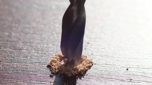 A Close Up of a Drill Bit Making a Hole in a Piece of Wood