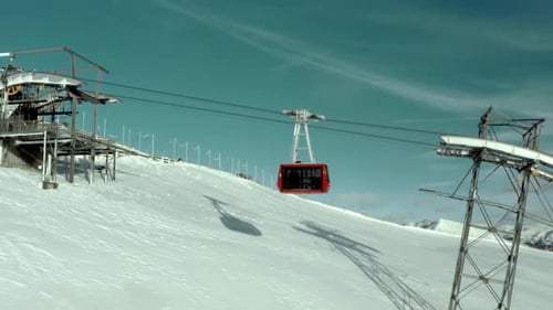 High Altitude Thrills Red Gondola Ascends Snowy Mountain Peaks