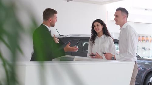 A Married Couple Signs an Order for the Purchase of a Car at a Car Dealership Car Salesman