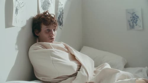 Disoriented Patient in Straitjacket Listening to Doctor in Psychiatric Ward