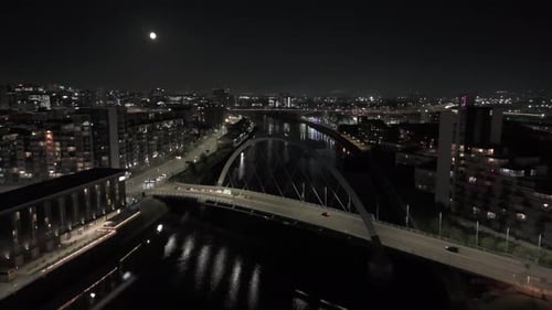 Clyde Arc curves through moonlit skies, silver bow where the river lies