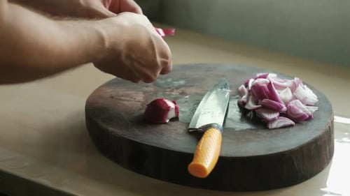 Chopping Red Onion on Wooden Cutting Board