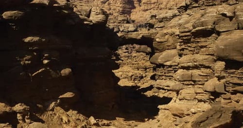 Rock Formations Illuminated By Sunlight in Arid Landscape During Midday
