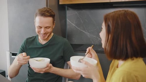 Couple Eating Breakfast Together in Kitchen