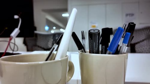 Close Up Of Pens And Markers In Mugs On Office Desk For Creative Workspace And Stationery Concepts
