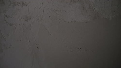 Construction worker smoothing plaster on a wall