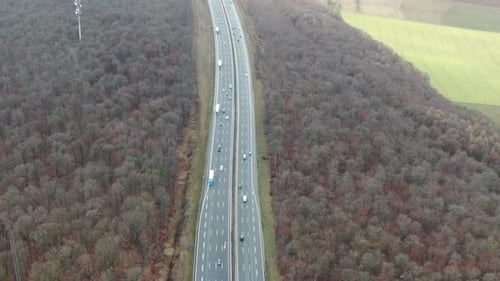Aerial footage of the highway and forests and fields around it, 4k