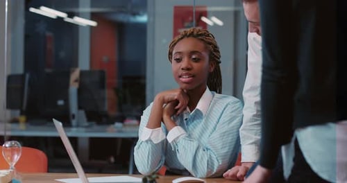 Four Attractive Colleagues Spending Evening Together in Modern Office in Center of Large City Young