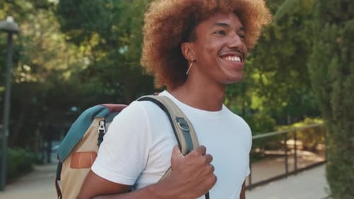 A young guy happily greets a female friend on the street, a happy meeting of friends