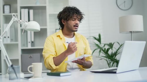 Young Adult Man Working Remotely at Home Office