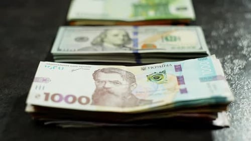 Stacks of Ukrainian Hryvnia, US Dollars and Euros