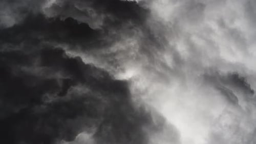 a thunderstorm with lightning that flashed through the dark clouds.