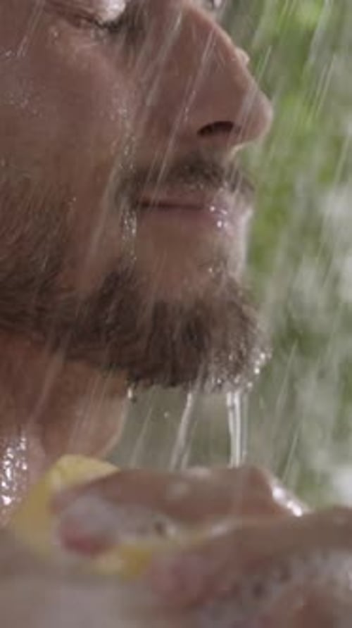 Man Taking Shower With Sponge And Water