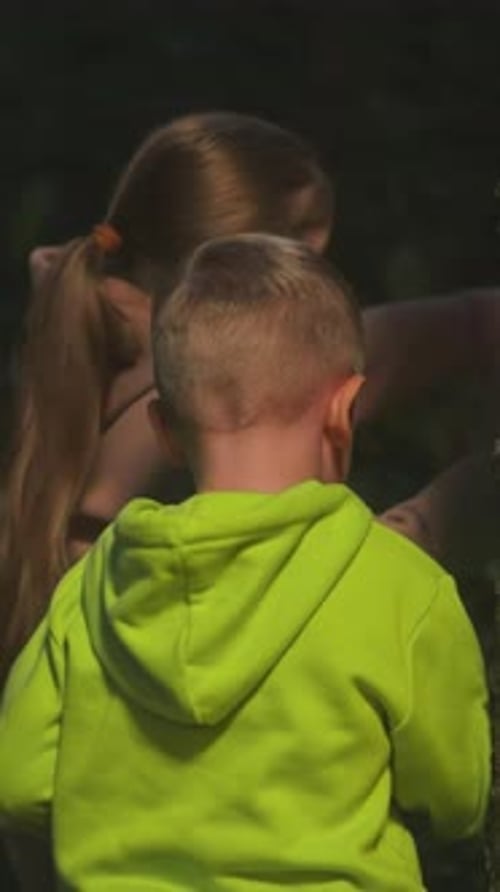 Children Siblings Walk in Night Nature Park Together