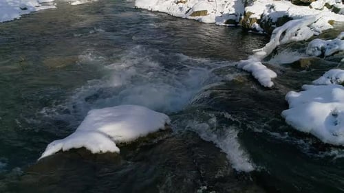 Stream of a Mountain River on a Winter Sunny Day