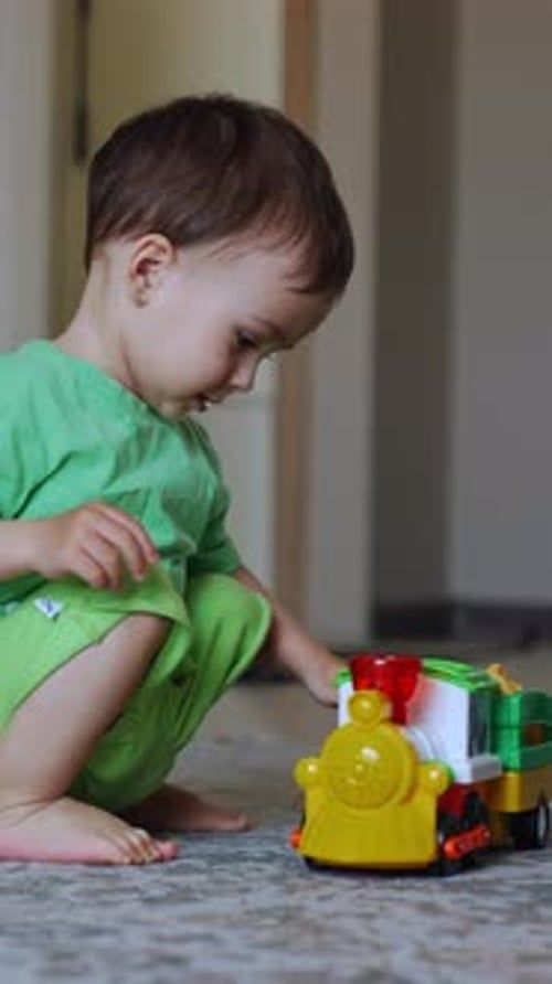 Adorable Toddler Playing With Toy Train